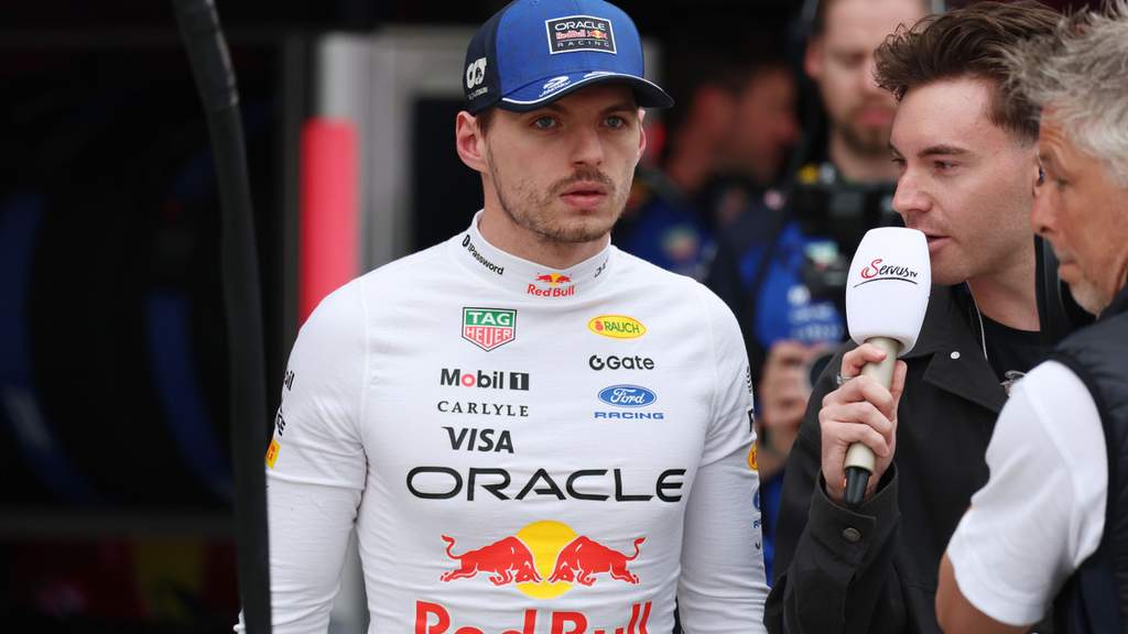 Max Verstappen walking through the paddock in Red Bull team gear