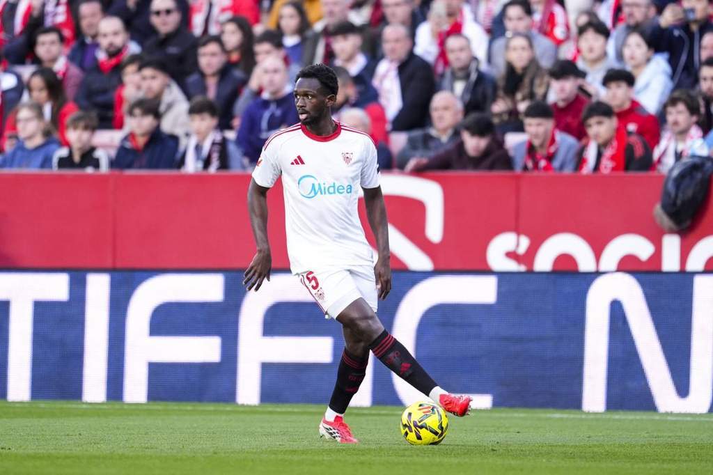 Tanguy Kouassi holding the Lille OSC jersey after signing his contract.