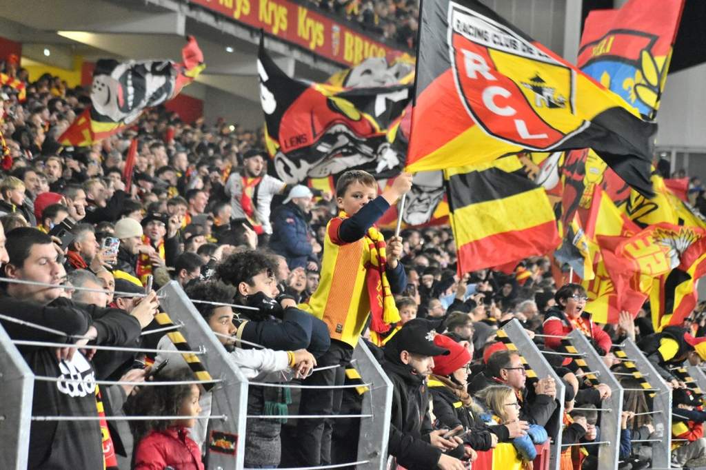 Passionate RC Lens supporters cheering inside Stade Bollaert-Delelis